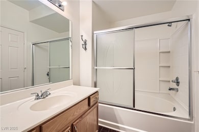 Full bath with vanity and combined bath / shower with glass door
