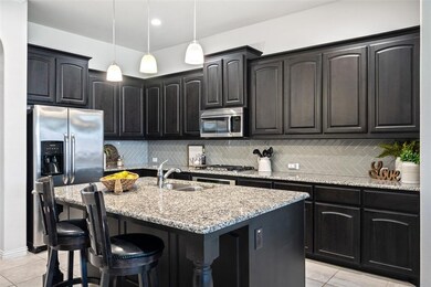 Gorgeous kitchen features stainless steel applianc