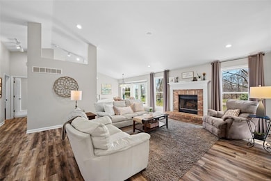 Sun lit open floor plan with vaulted great room wi