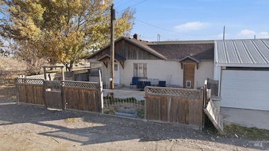 View of front of house featuring a fenced front yard, a patio area, a gate, and roof with shingles