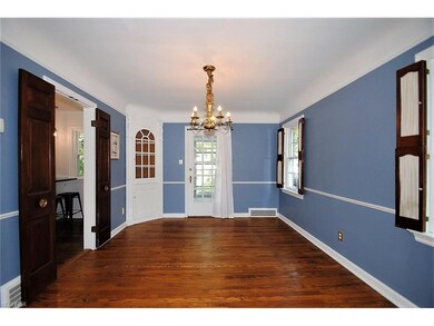 FORMAL DINING ROOM BOASTS WOOD FLOORING, TWO BUILT
