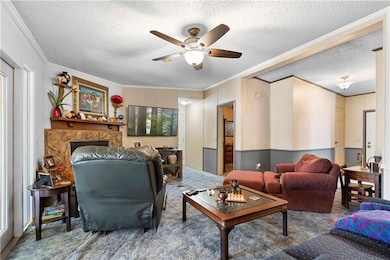 Living area featuring a textured ceiling, ornament
