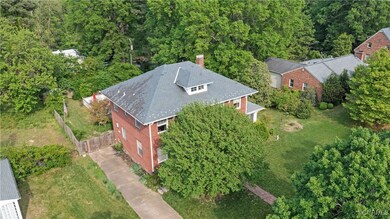 Birds eye view of property featuring a wooded view