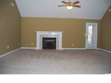 Large great room with vaulted ceiling and gas log fireplace