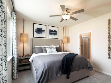 Bedroom with carpet floors, ensuite bath, a ceili