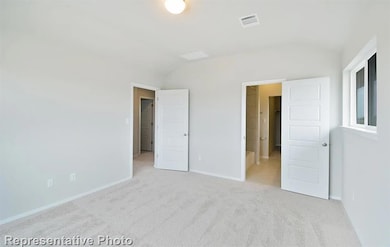Unfurnished bedroom featuring lofted ceiling and 