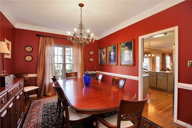 Formal dining room with chair rail and crown moldings.