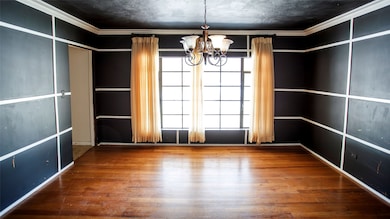 Unfurnished dining area with crown molding, wood-type flooring, and a chandelier