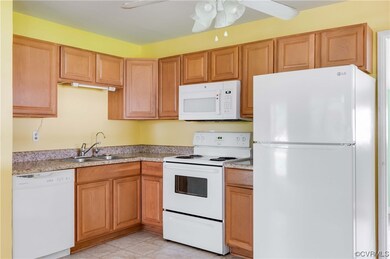 Kitchen with ceiling fan, white appliances, light