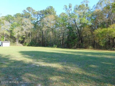 View of property & rear wooded area