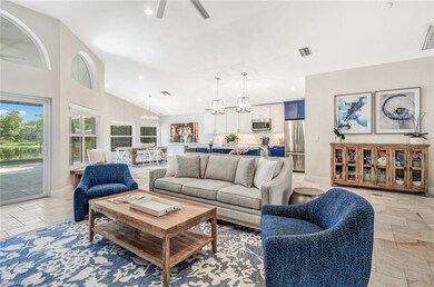 Living room featuring ceiling fan with notable cha