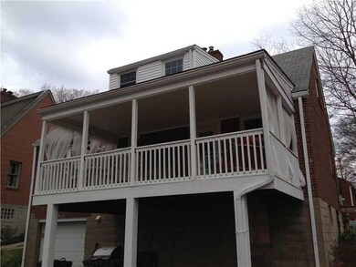 Exterior Back. A  very welcoming covered deck/porc