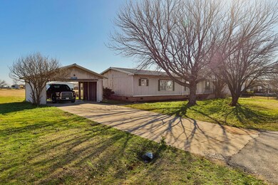 Another view of the front of the home showing the 2 car carport.