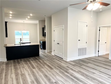 Living room featuring light wood-style floors and ceiling fan