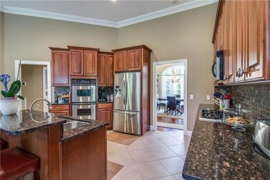 Chef's kitchen.  Full compliment of stainless steel appliances, huge pantry, custom cabinets, granite counter tops, tile back splash, breakfast bar, open to Hearth room