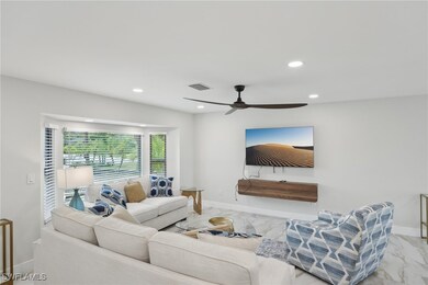 Living area with marble look tiles, ceiling fan, r