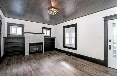 *LIVING RM FEATURES A TILED FIREPLACE BETWEEN DUAL