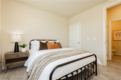 Bedroom downstairs with baseboards and light wood-