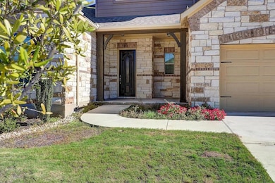 Entrance to property featuring stone siding and a