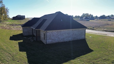View of home's exterior with brick siding and a yard