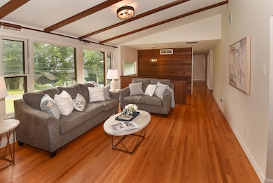 Expansive newer windows let natural light shine on gleaming hardwood floors!