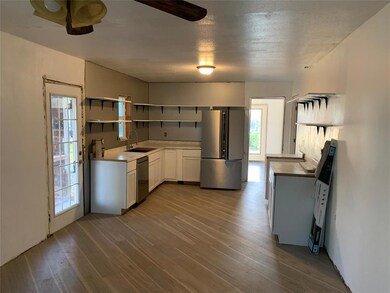 Kitchen with ceiling fan, hardwood / wood-style fl