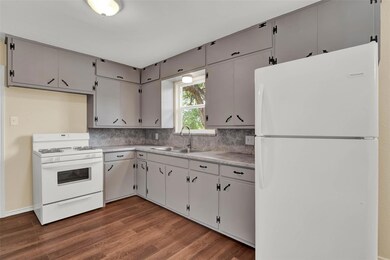 Kitchen with backsplash, sink, gray cabinets, whit