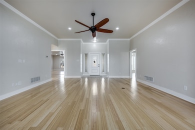 Unfurnished living room with crown molding, light wood-style flooring, healthy amount of natural light, a ceiling fan, and recessed lighting