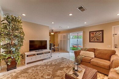 Enter into large living room with recessed lighting and porcelain tile flooring.