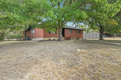 View of property exterior featuring brick siding and a central AC unit