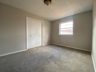 Unfurnished bedroom with a closet, carpet floors, 