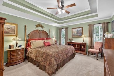Spacious master suite has a cozy sitting area and double trey ceiling.
