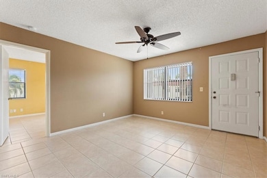 Empty room featuring a ceiling fan, a textured cei