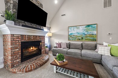 Cozy up to the brick and stone fireplace in the living room.