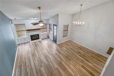 Unfurnished living room with ceiling fan, a textu