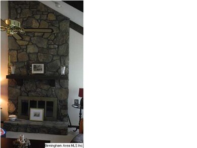 Massive stone fireplace in living room features ga