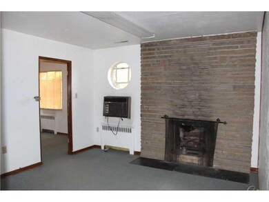 Living Room. Stone woodburning fireplace in living