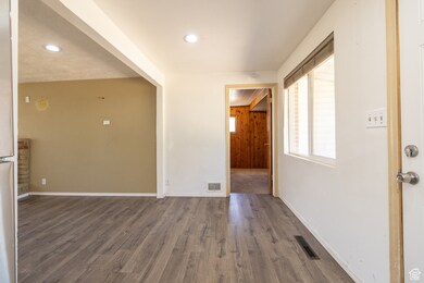 Spare room with wood finished floors and recessed lighting