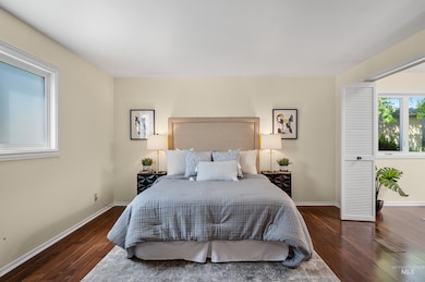 Bedroom featuring wood finished floors and baseboards
