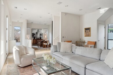 Living room with stairs and recessed lighting