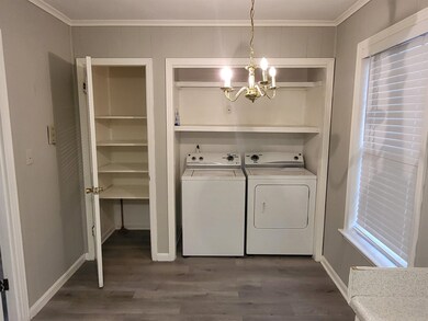 Washroom featuring an inviting chandelier, crown m