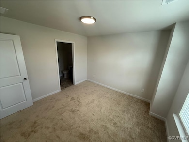 Unfurnished bedroom with baseboards, carpet floori