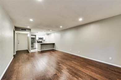 Unfurnished living room featuring dark wood-type f