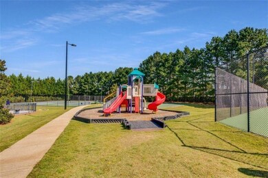 Community playground featuring a lawn and fence