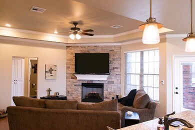 Living room with floor to ceiling stone fireplace