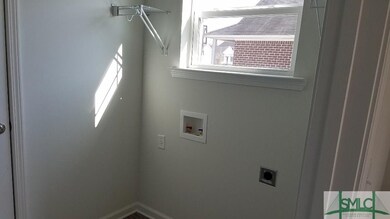 Laundry room with a window.