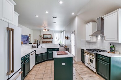 Kitchen featuring ceiling fan, wall chimney exhaus