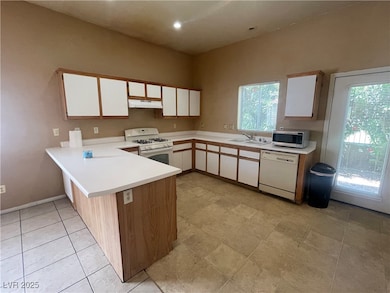 Kitchen with white appliances, under cabinet range