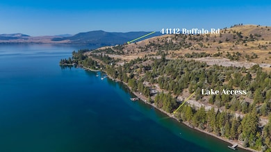 Aerial view of property and surrounding area with a water and mountain view