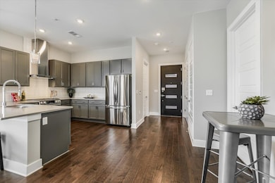 Kitchen with a sink, backsplash, wall chimney exh